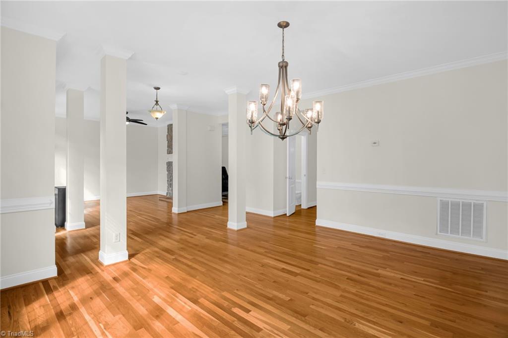 8916 Grove Park Drive Oak Ridge, NC 27310 - Photo 4 of 29 Formal dining room and living room with polished hardwood floors