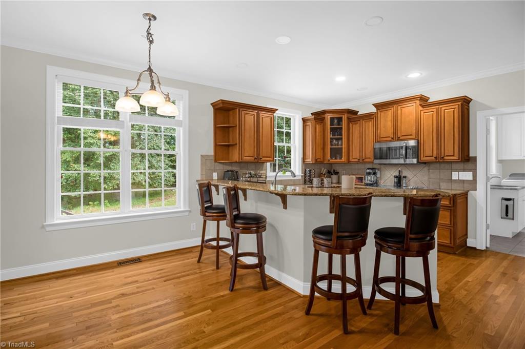 8916 Grove Park Drive Oak Ridge, NC 27310 - Photo 10 of 29 Kitchen counter seating and breakfast area