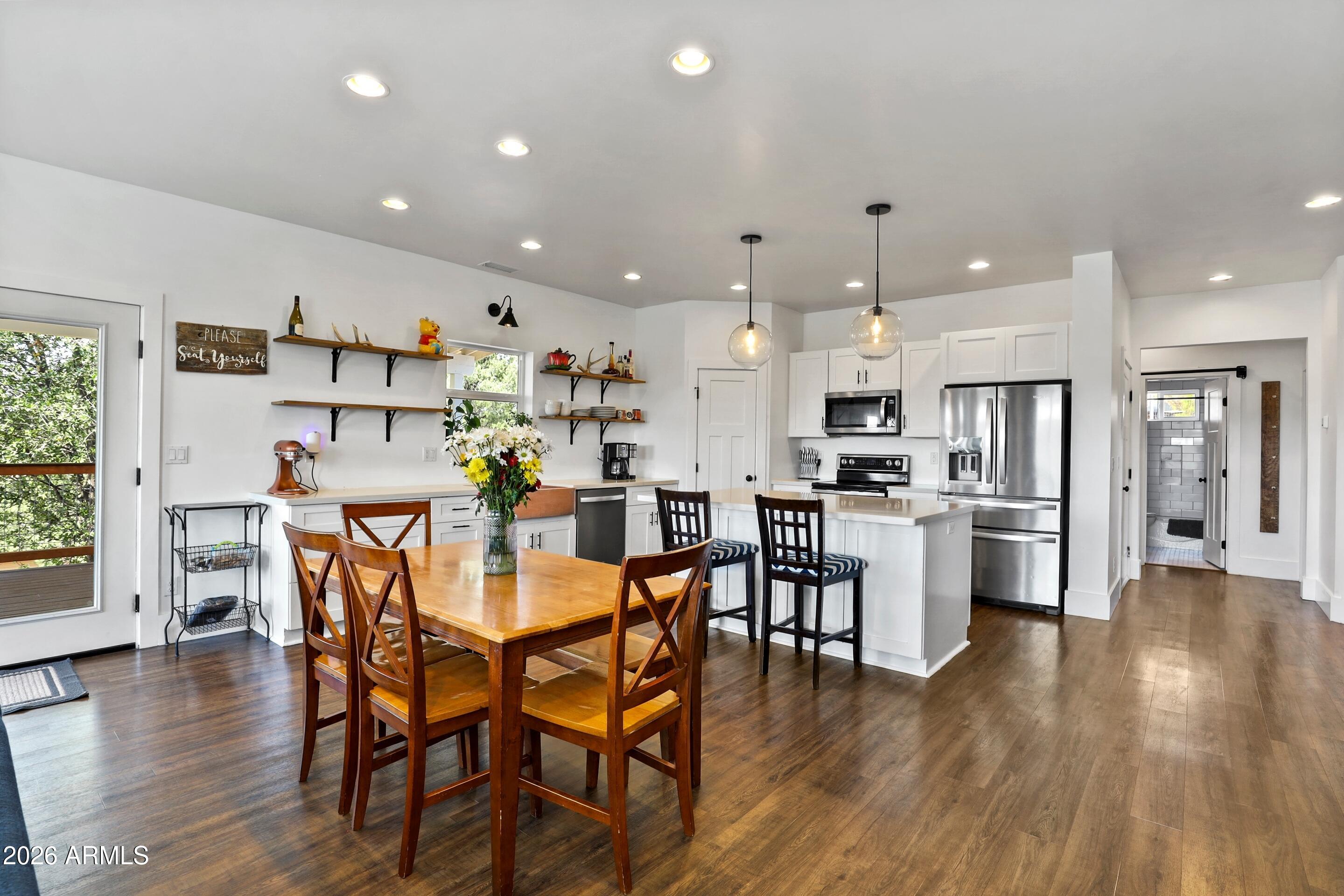 102 North Lookout Point Payson, AZ 85541 - Photo 8 of 25 a view of a dining area with furniture wooden floor and a kitchen