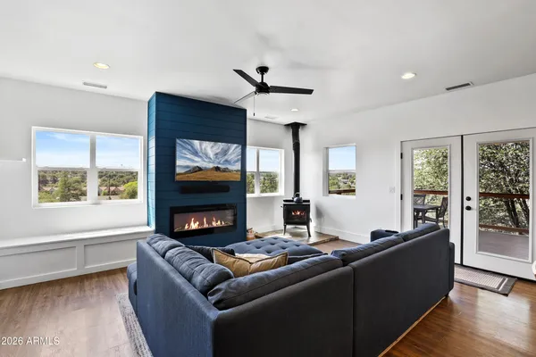 a kitchen with stainless steel appliances kitchen island granite countertop a table chairs refrigerator and microwave