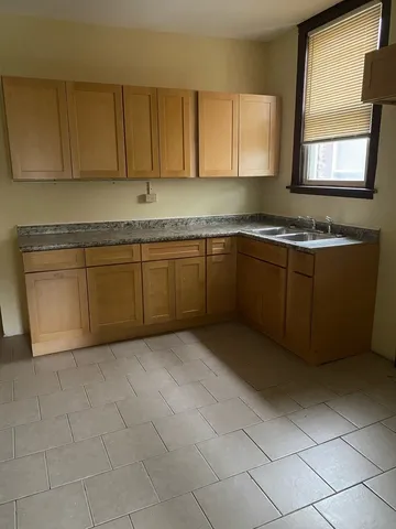 a kitchen with stainless steel appliances granite countertop a sink and cabinets