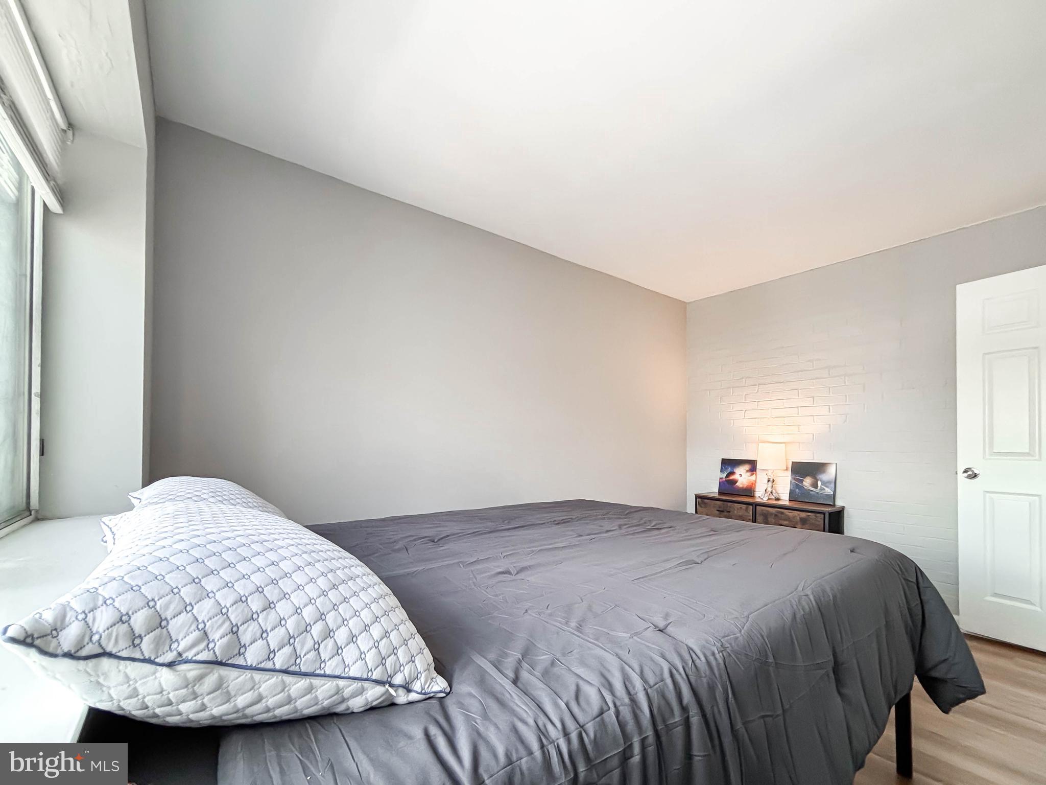 130 Slade Avenue, Unit 414 Baltimore, MD 21208 - Photo 47 of 48 a bedroom with a bed and a lamp