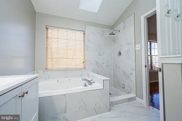 a bathroom with a bathtub and a shower