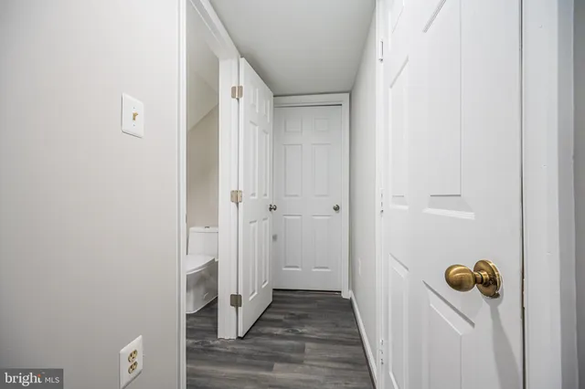 a view of a room with a wooden door