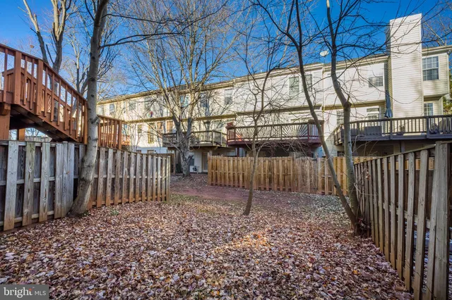 a view of a backyard with wooden fence