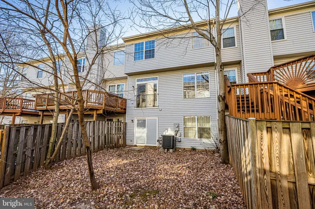 a view of a house with a wooden fence
