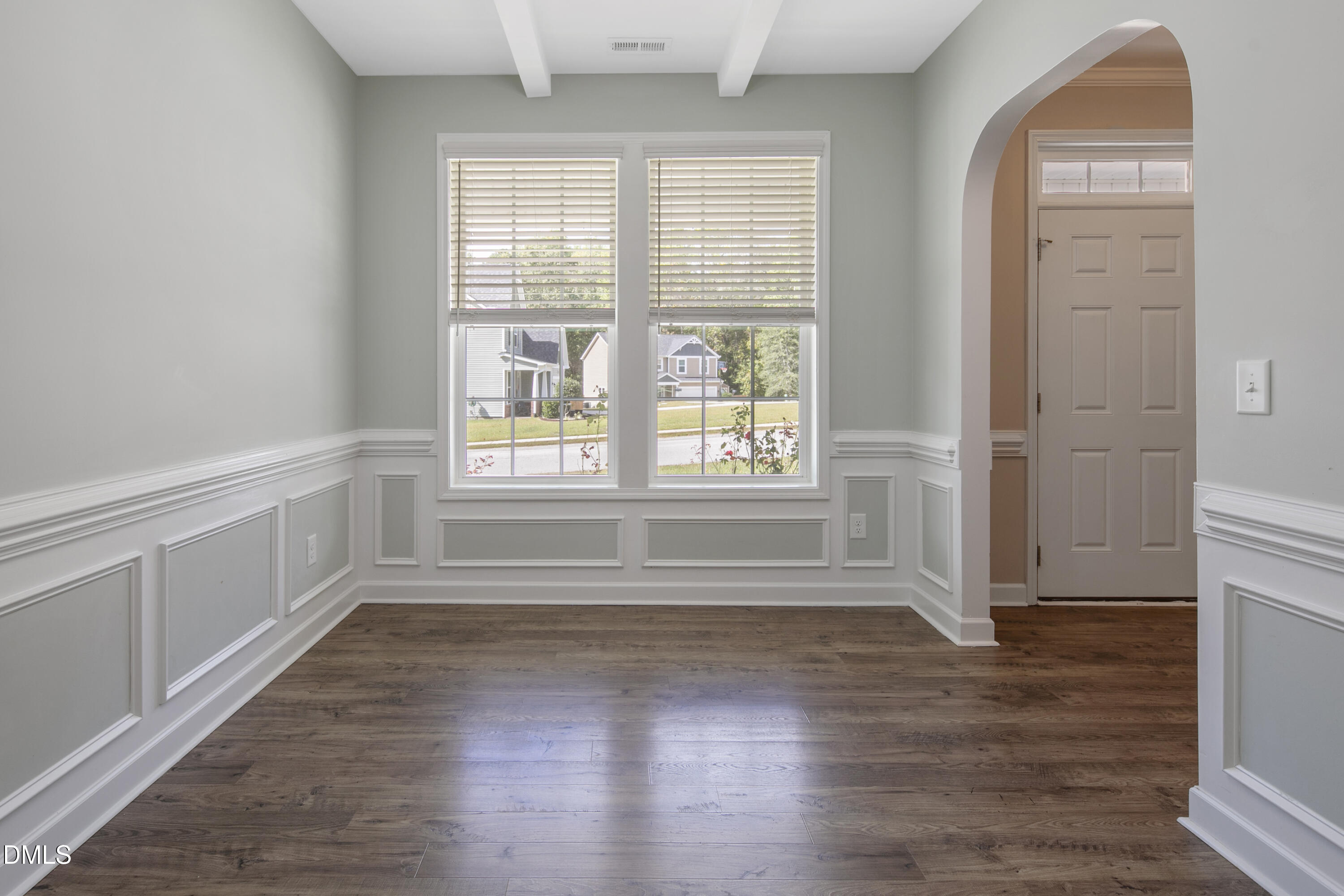 296 Birch Avenue Spring Lake, NC 28390 - Photo 9 of 37 an empty room with wooden floor and windows