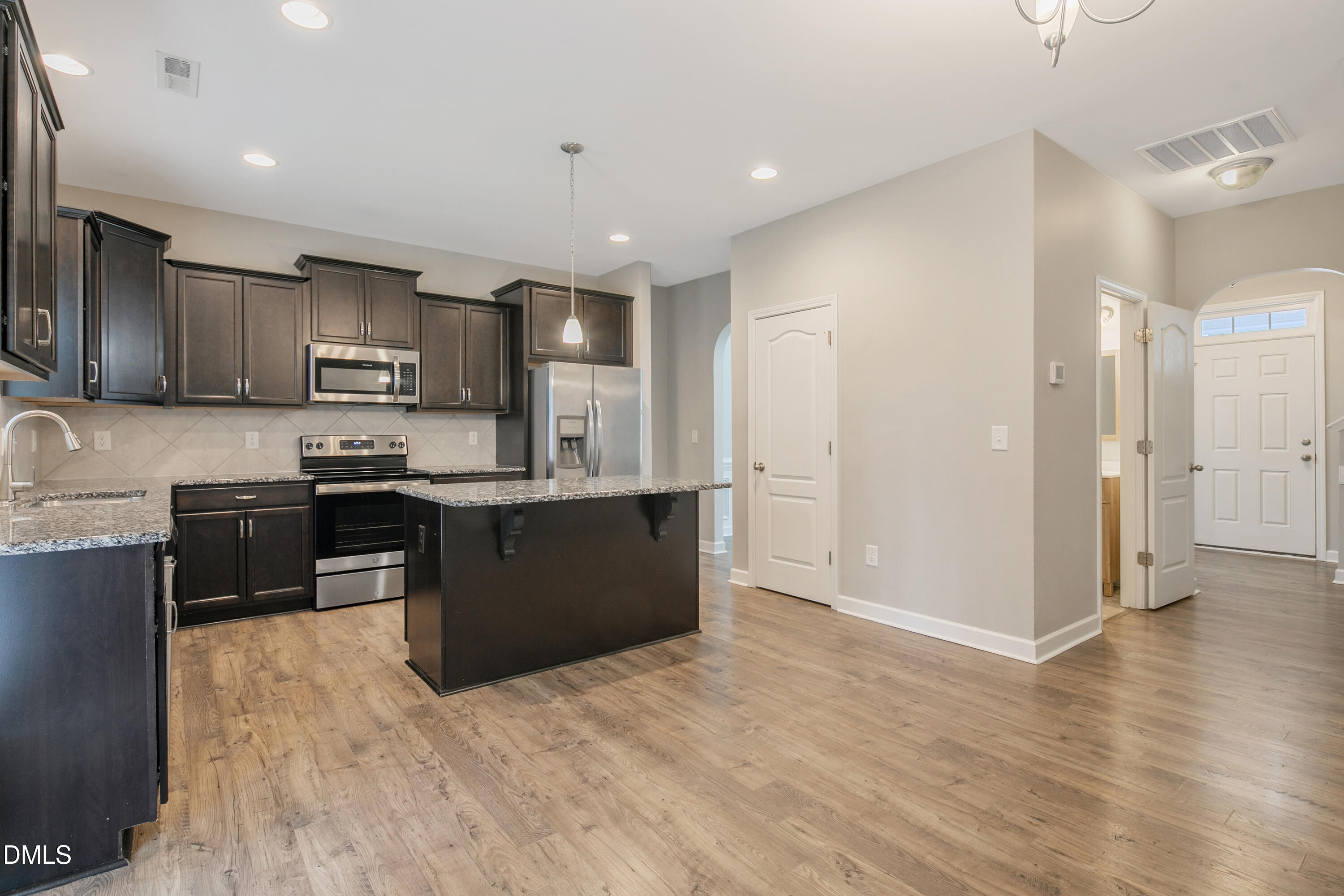 296 Birch Avenue Spring Lake, NC 28390 - Photo 12 of 37 a kitchen with stainless steel appliances granite countertop a refrigerator stove top oven and sink