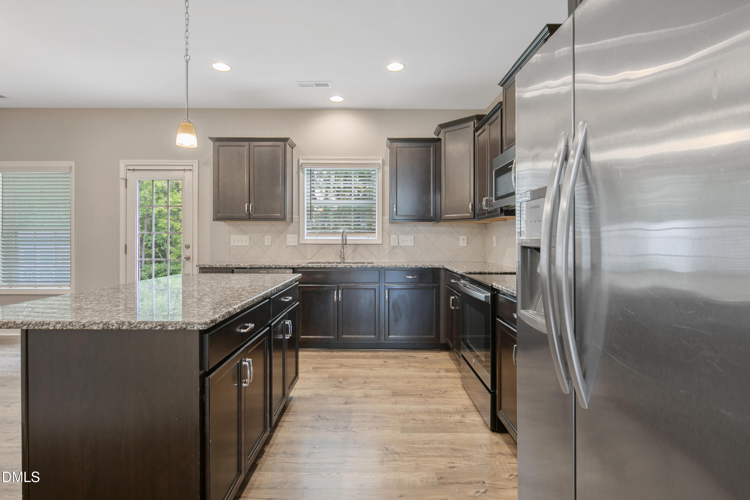 296 Birch Avenue Spring Lake, NC 28390 - Photo 13 of 37 a kitchen with kitchen island granite countertop a sink a counter top space stainless steel appliances and a window