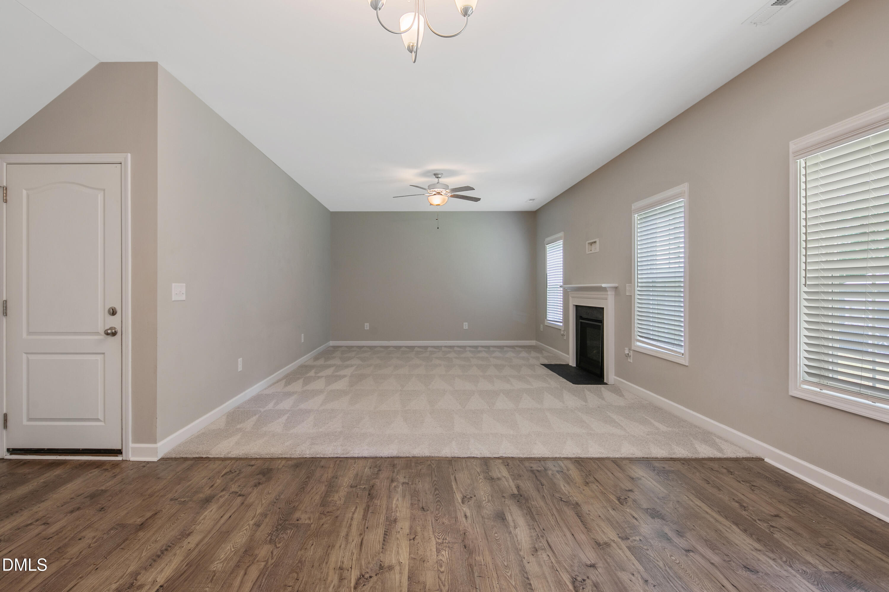 296 Birch Avenue Spring Lake, NC 28390 - Photo 16 of 37 an empty room with wooden floor and windows