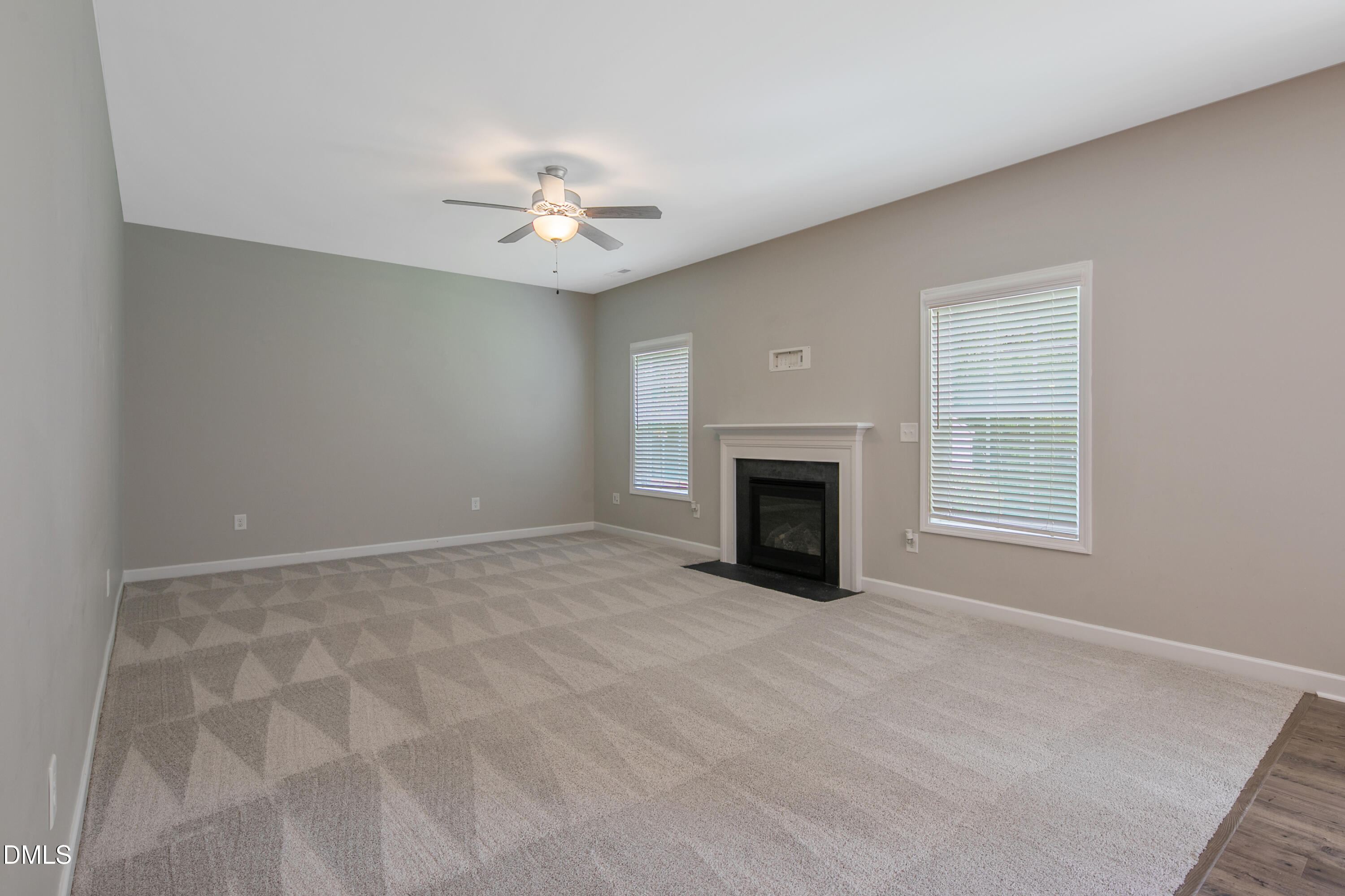 296 Birch Avenue Spring Lake, NC 28390 - Photo 17 of 37 en empty room with windows and fireplace