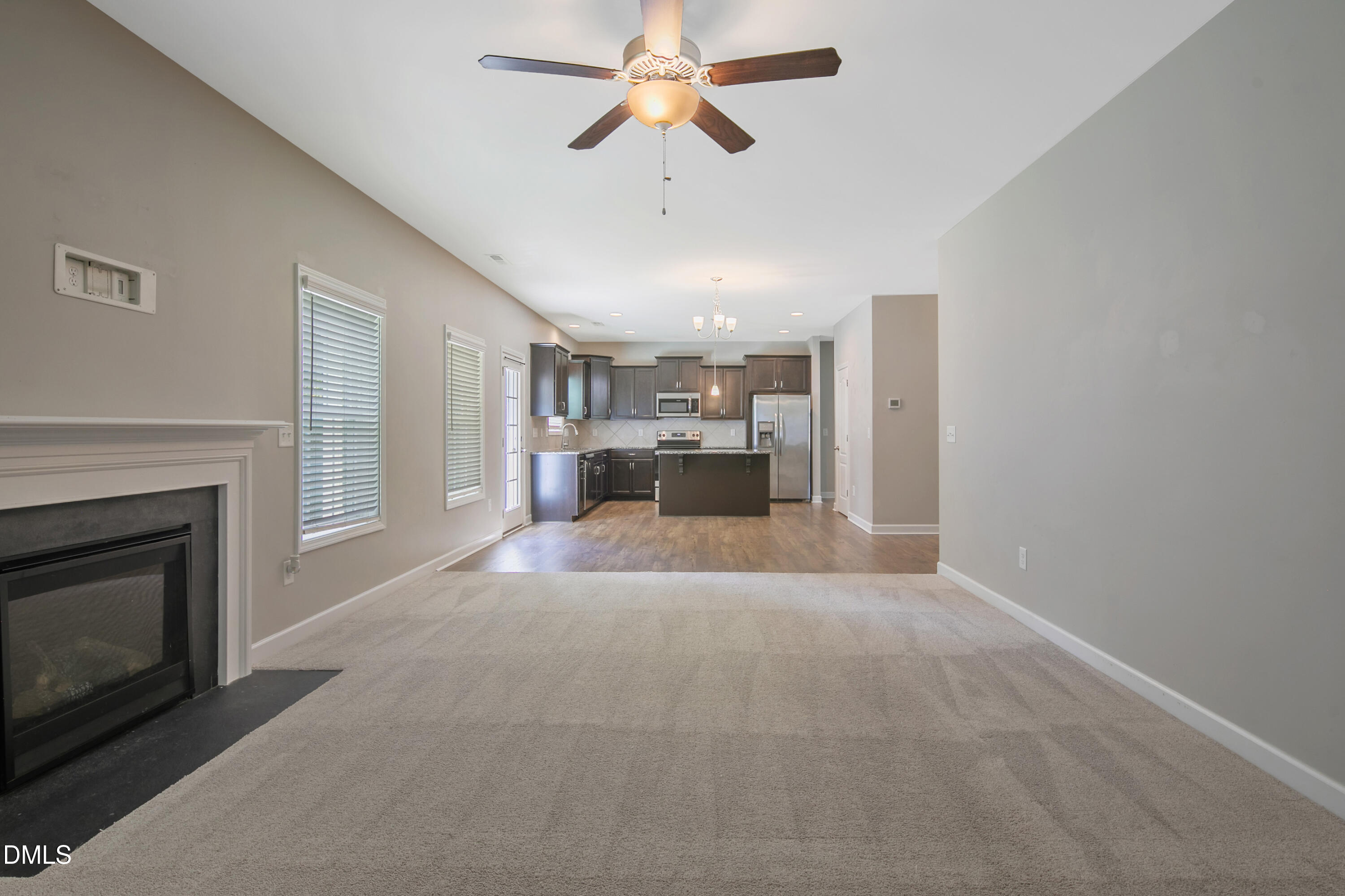 296 Birch Avenue Spring Lake, NC 28390 - Photo 18 of 37 a view of a livingroom with a fireplace and a chandelier fan