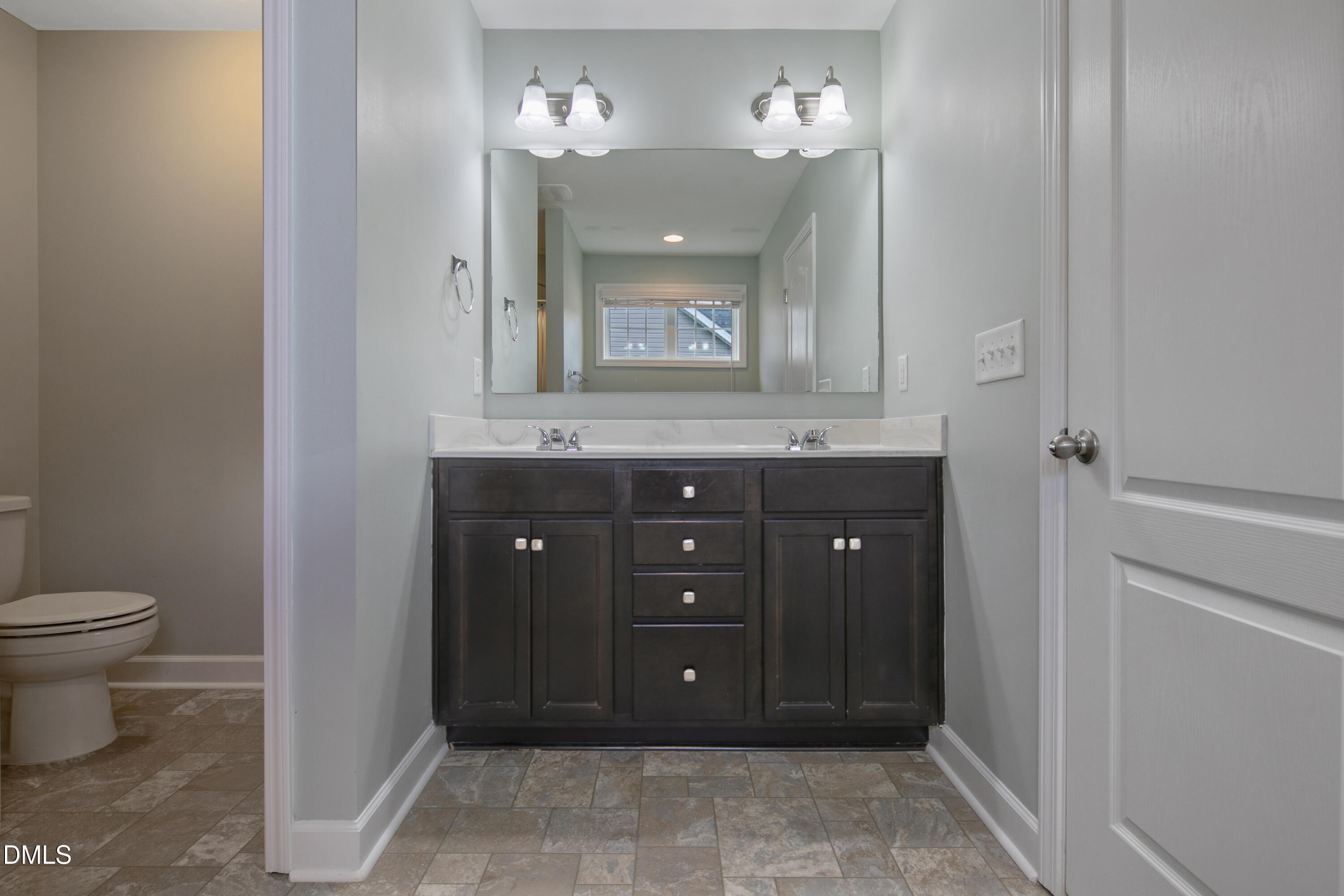 296 Birch Avenue Spring Lake, NC 28390 - Photo 21 of 37 a bathroom with a granite countertop sink a toilet and a mirror