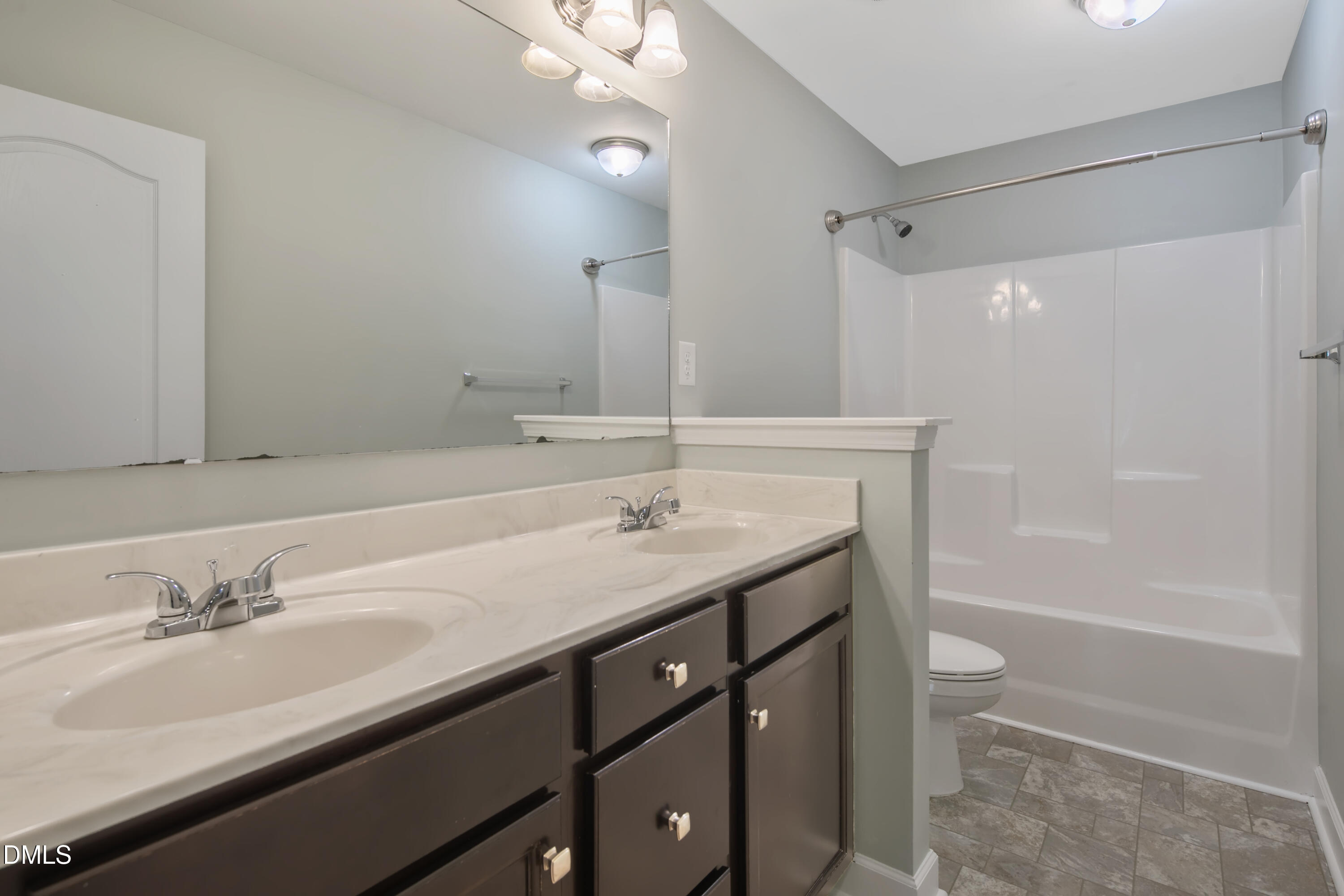 296 Birch Avenue Spring Lake, NC 28390 - Photo 27 of 37 a bathroom with a granite countertop sink a toilet a shower and a mirror
