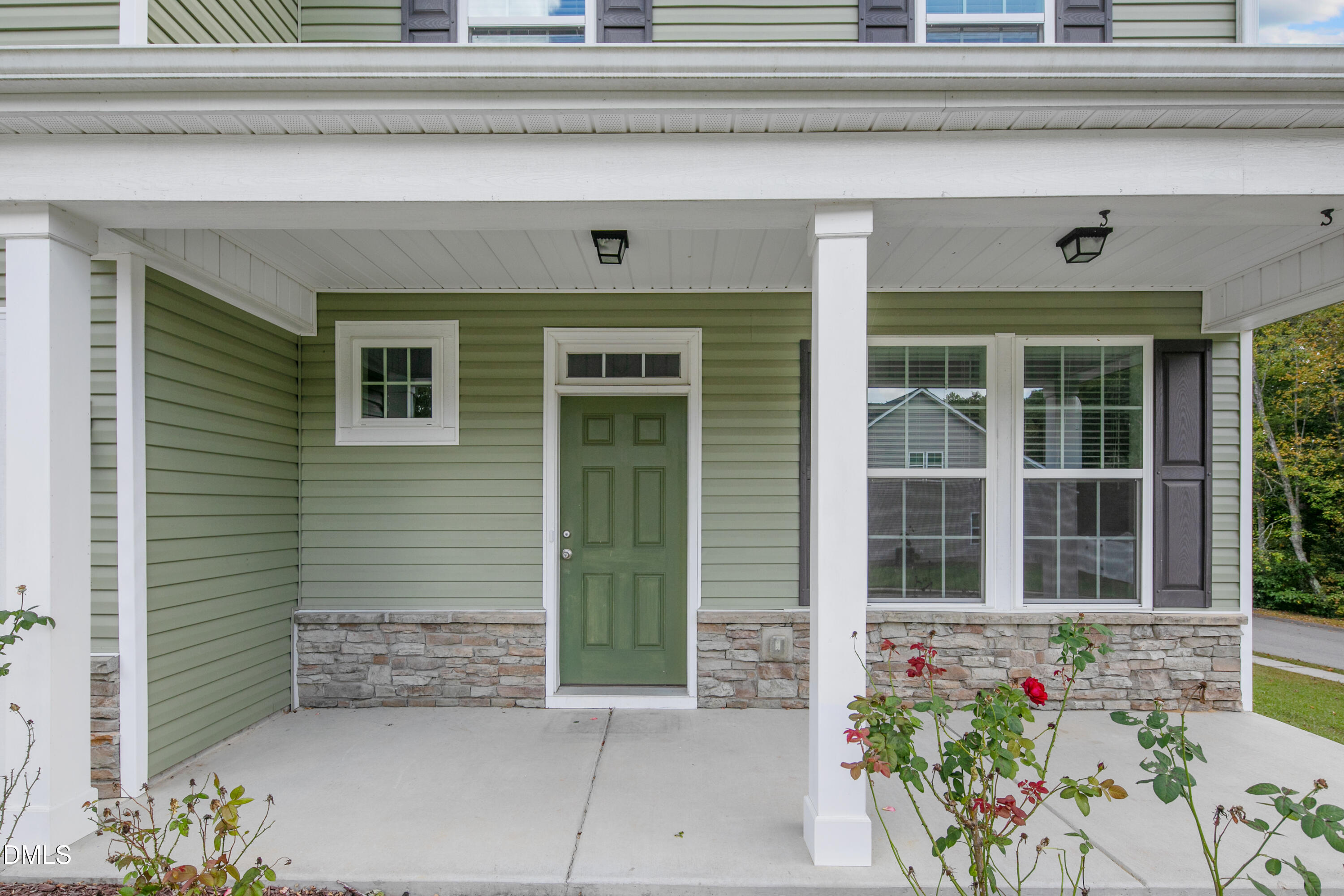 296 Birch Avenue Spring Lake, NC 28390 - Photo 6 of 37 a front view of a house with a flower garden