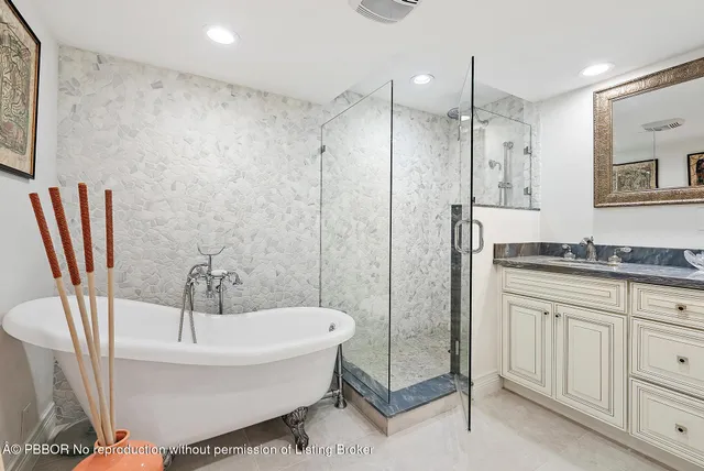a bathroom with a granite countertop sink a toilet a mirror and shower