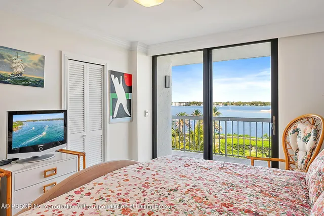 a bedroom with furniture and a flat screen tv