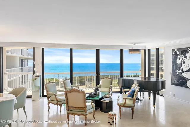 a view of living room with furniture and floor to ceiling windows