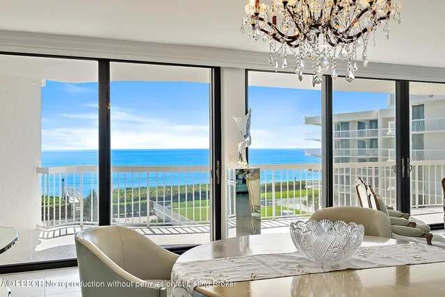 a living room with furniture and large windows