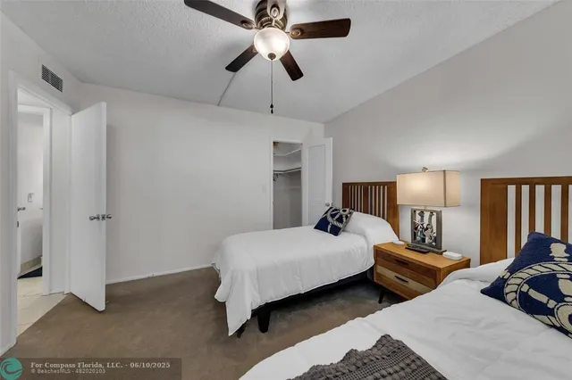 a bedroom with two beds and a chandelier