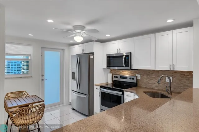 a kitchen with stainless steel appliances granite countertop a refrigerator stove and microwave