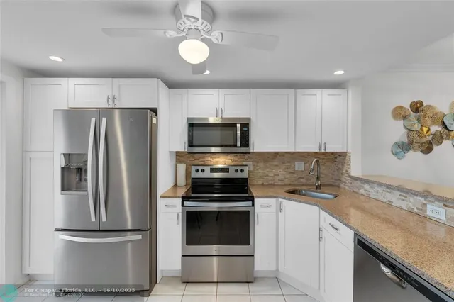 a kitchen with a refrigerator stove and microwave