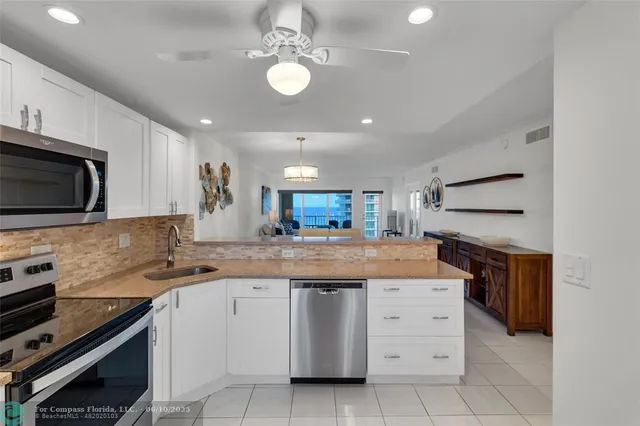 a kitchen with a sink stove and microwave