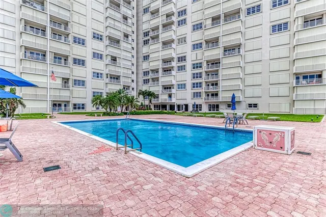 a view of a swimming pool with a lounge chairs