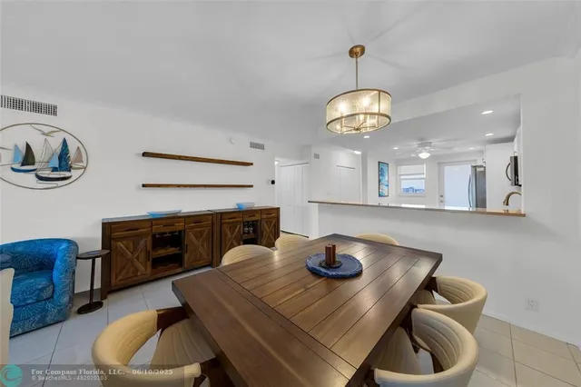 a dining room with furniture and a chandelier