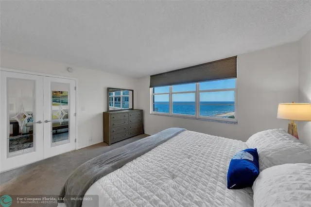 a bedroom with a bed and a large window