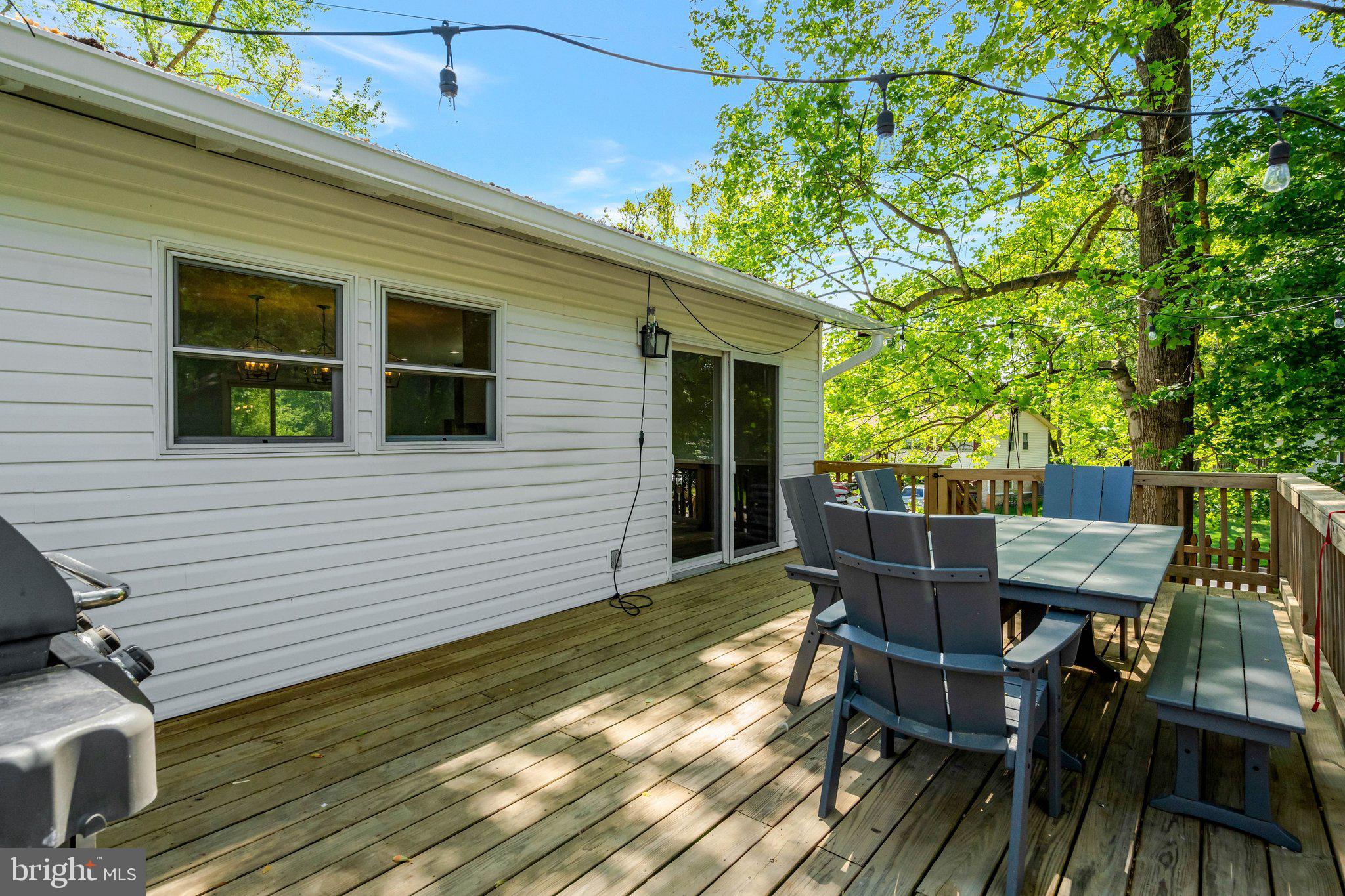7212 Galgate Drive Springfield, VA 22153 - Photo 29 of 39 a view of a patio with table and chairs with wooden floor and fence