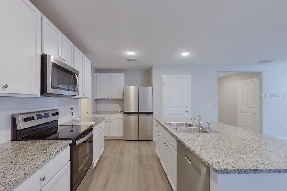 4397 Southwest 85th Lane Ocala, FL 34476 - Photo 4 of 23 a kitchen with a sink stove and microwave