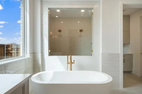 a bathroom with a tub and a sink