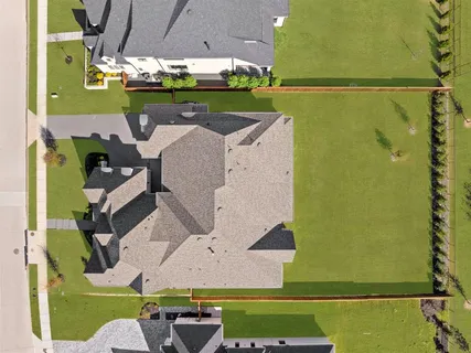 an aerial view of a house with a yard