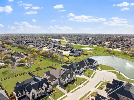 an aerial view of a swimming pool a yard and mountain view in back