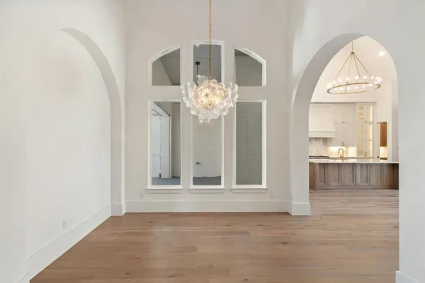 a view of a livingroom with wooden floor and a large window