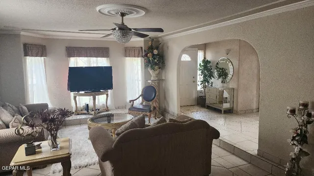a living room with furniture and a chandelier