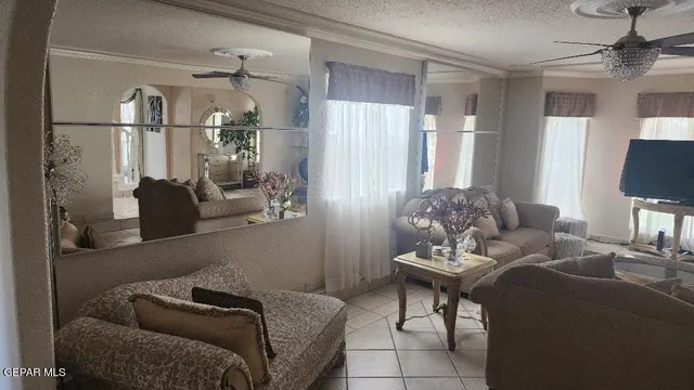a living room with furniture and a chandelier