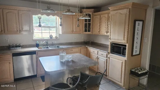 a kitchen with stainless steel appliances granite countertop a sink and a refrigerator
