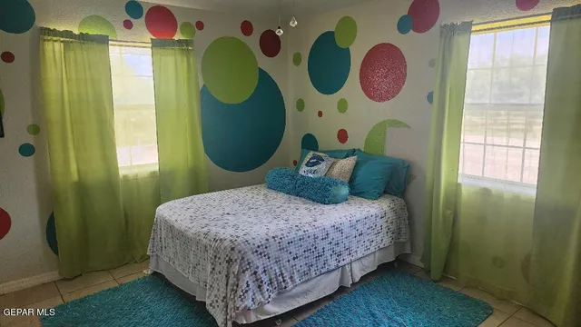 a bedroom with a bed and windows