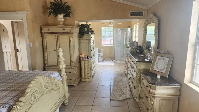 a bedroom with furniture and a large mirror