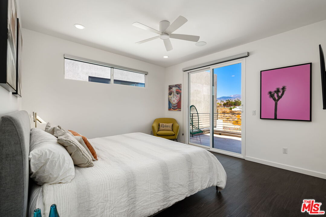 504 Paragon Loop Palm Springs, CA 92262 - Photo 15 of 19 a bedroom with a bed and a chandelier