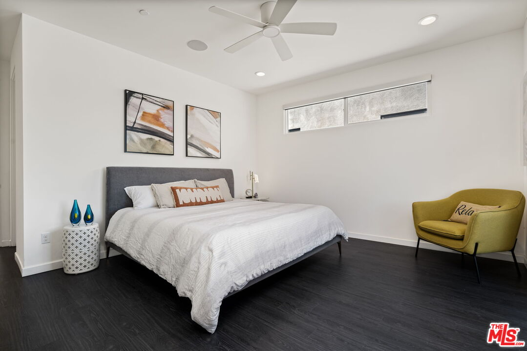 504 Paragon Loop Palm Springs, CA 92262 - Photo 16 of 19 a bedroom with a bed and a chair