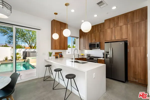 a kitchen with a sink a refrigerator and a stove