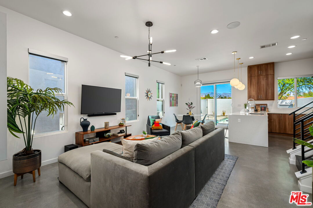 504 Paragon Loop Palm Springs, CA 92262 - Photo 5 of 19 a living room with furniture and a flat screen tv