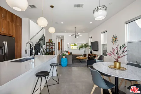 a living room with furniture gym equipment and a flat screen tv