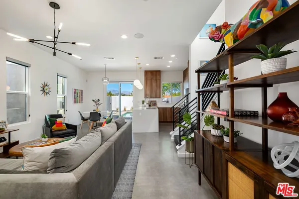 a bedroom with a bed and a potted plant