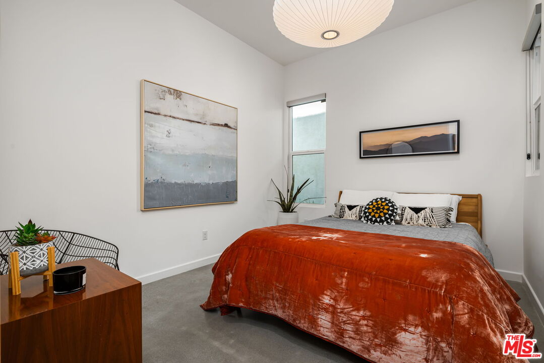 504 Paragon Loop Palm Springs, CA 92262 - Photo 9 of 19 a bedroom with a bed and a potted plant