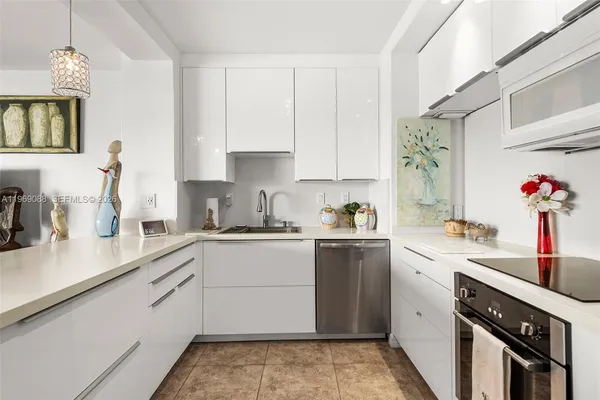 a kitchen with a sink cabinets and window
