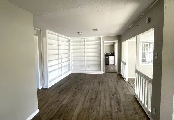 wooden floor in an empty room with a window